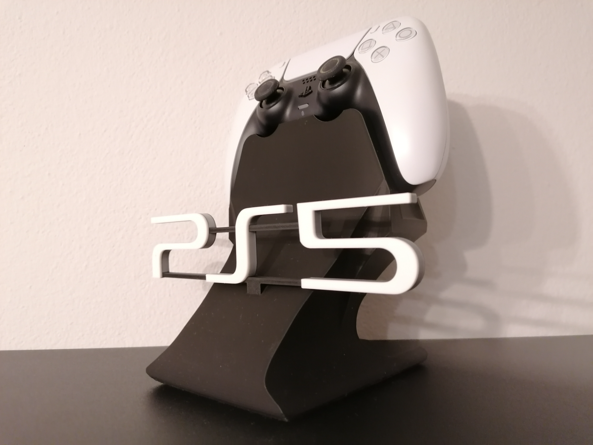 3D printed PS5 controller stand with modern design on a black surface, Lunqo style.
