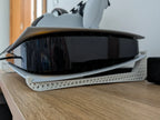 3D printed white honeycomb stand supporting a gaming console on a wooden surface