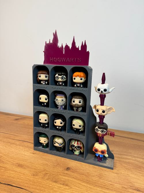 3D printed Hogwarts display stand with Harry Potter character figurines on wood surface