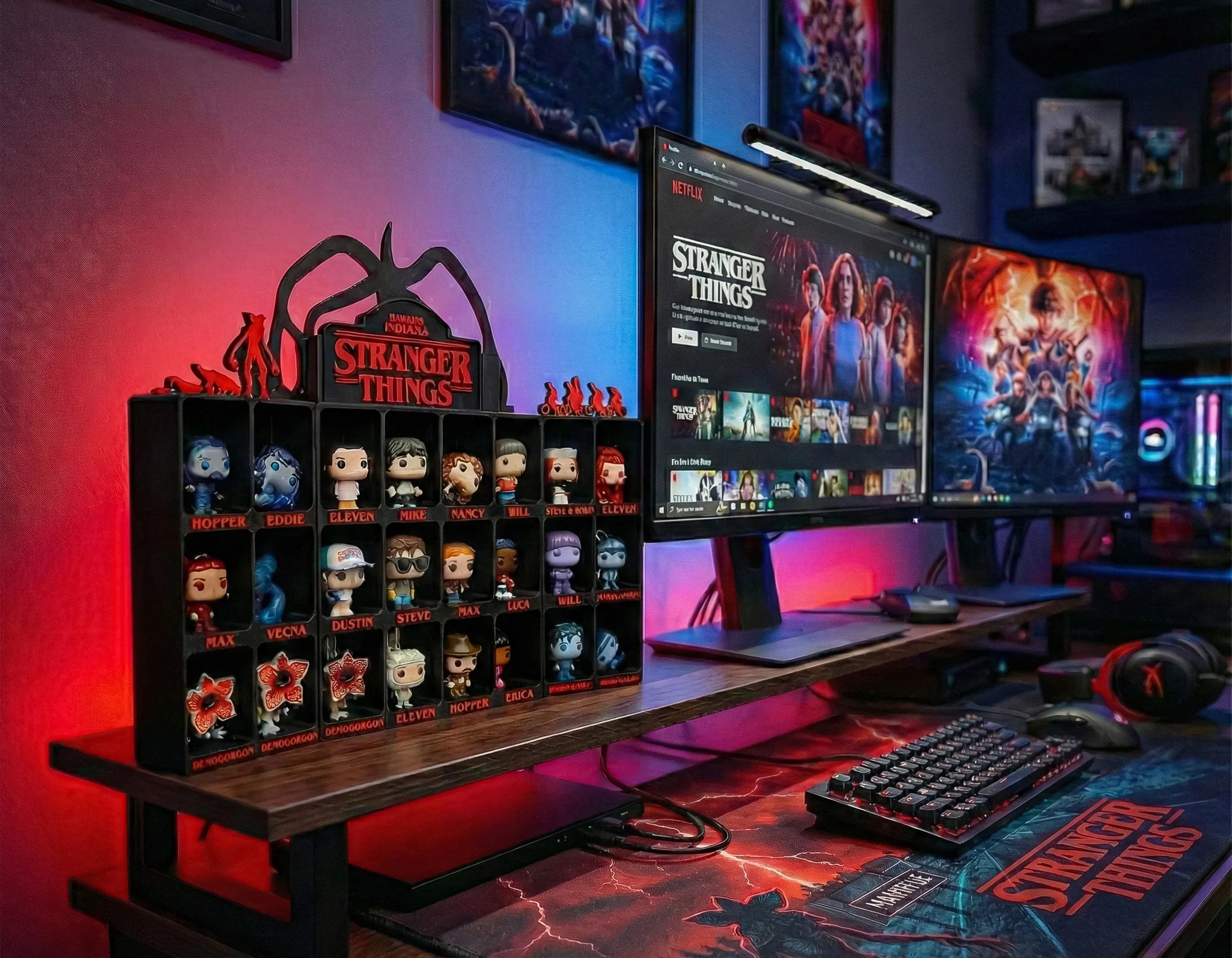 Stranger Things 3D printed display with Funko Pop figures on modern gaming desk, dual monitors, LED lighting