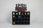 Black display case with 'Stranger Things' themed figurines on a white background