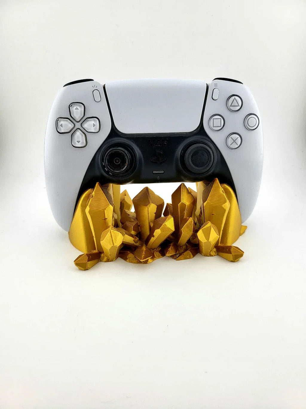 White gaming controller on gold 3D printed crystal stand, modern decor by Lunqo.