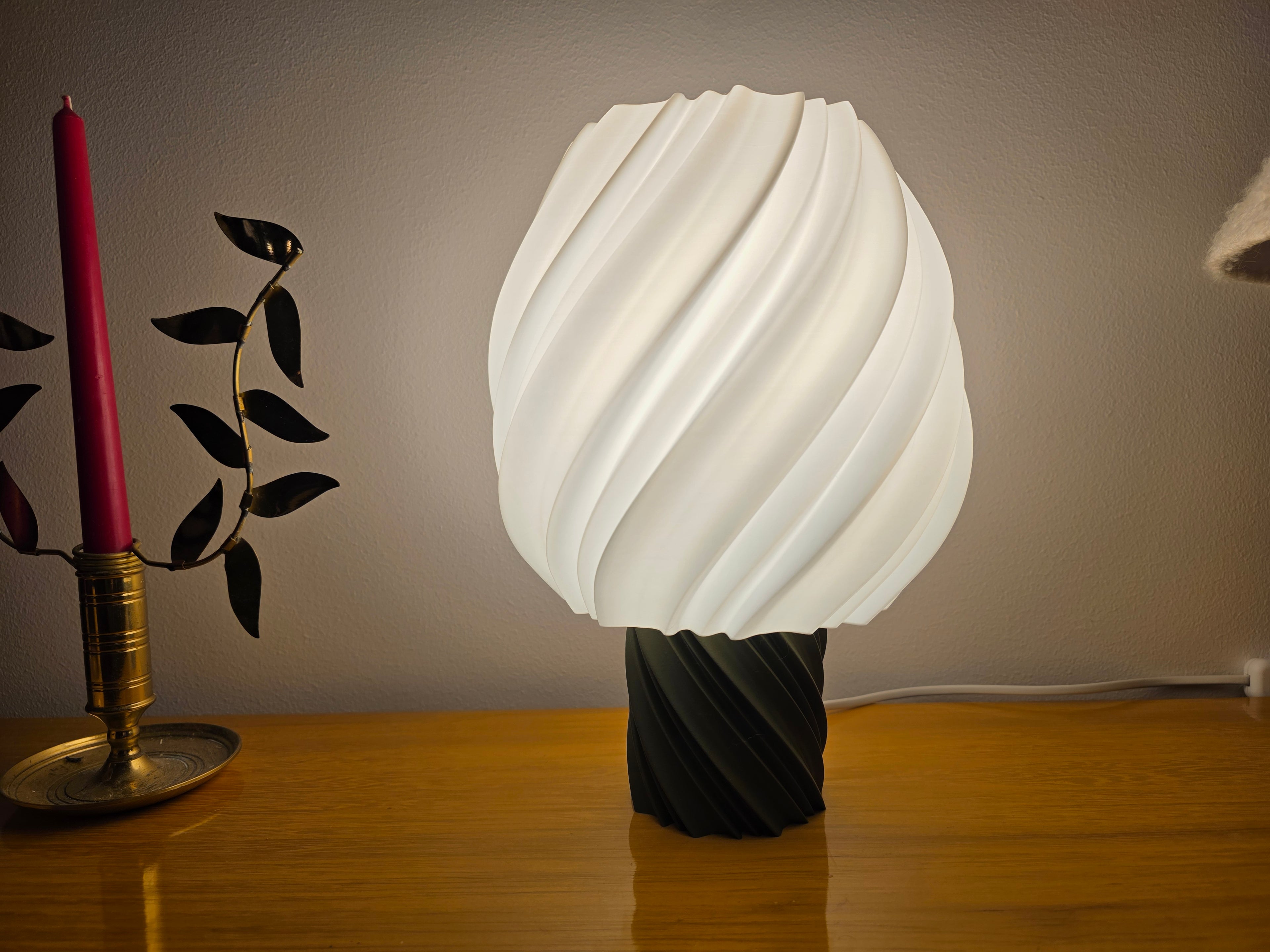 Modern 3D printed sculptural lamp by Lunqo with twisted white shade on wood table