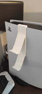 PlayStation console with a white stand attached, showing the brand logo.