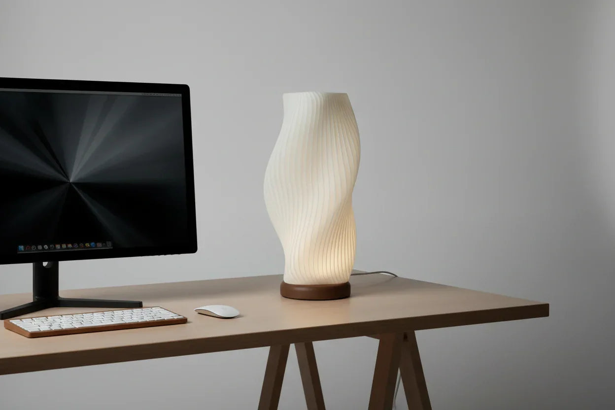 Modern 3D printed Lunqo table lamp with sculpted design on minimalist desk beside monitor