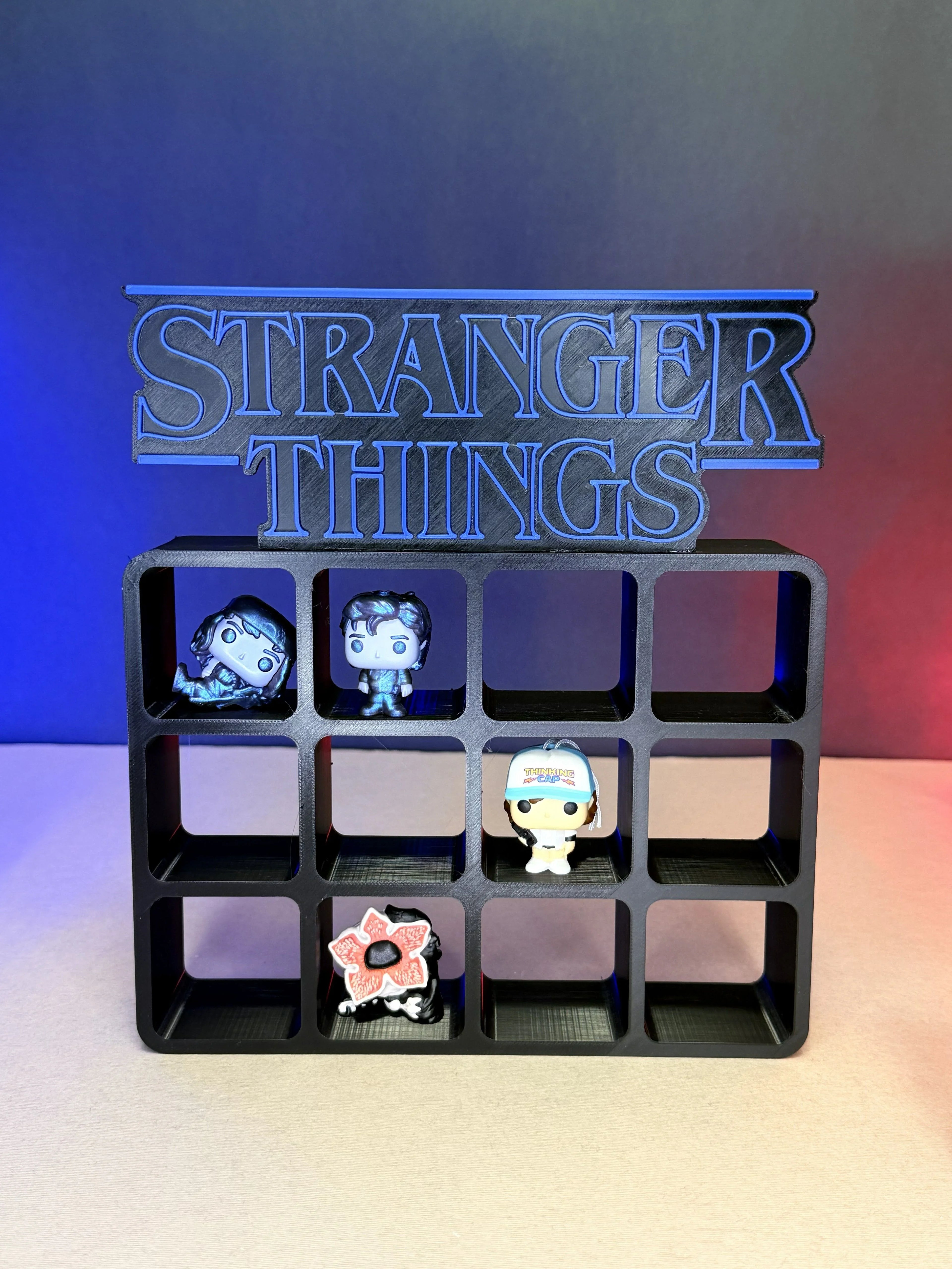 3D printed Stranger Things display stand with pop culture mini figures on grid shelves