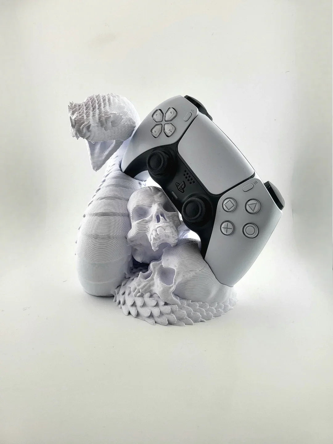 3D printed dragon skull PlayStation controller stand by Lunqo, modern white gaming desk accessory