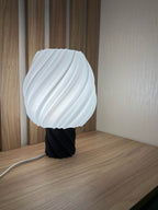 Lunqo 3D printed modern table lamp with spiral design, lit on wooden surface indoors
