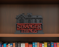 Stranger Things logo on a shelf with books