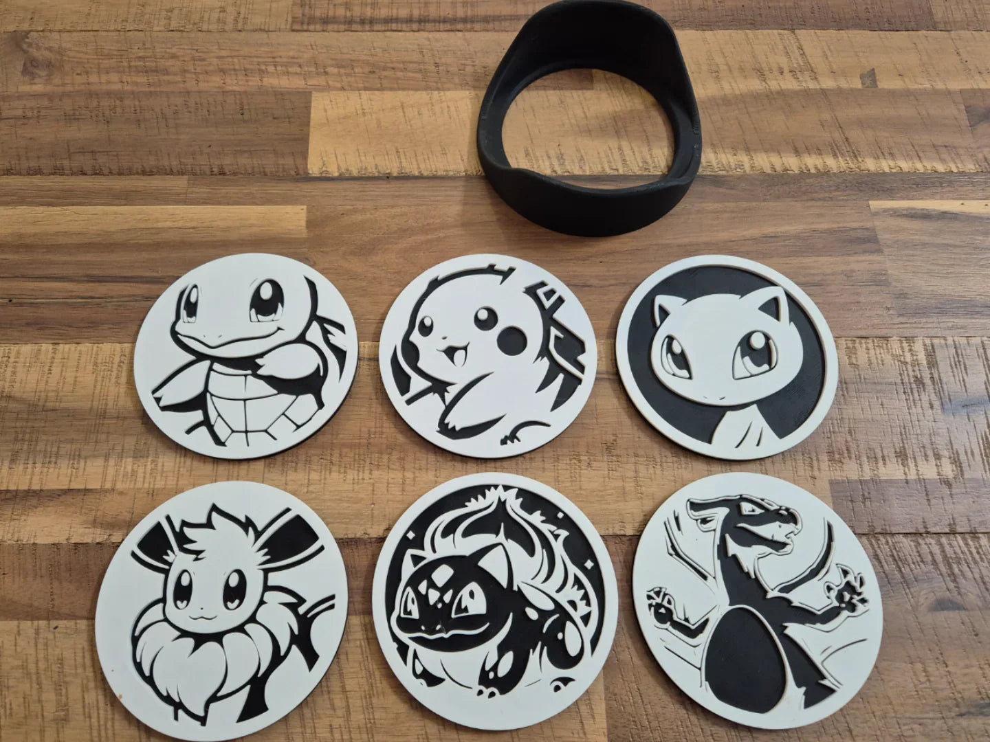 Lunqo 3D printed coasters with popular cartoon creature designs on wood table