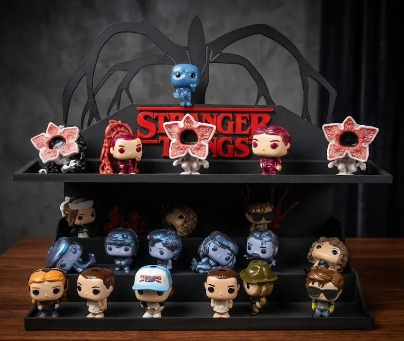 Collection of Stranger Things figurines on a display stand with a dark background.