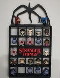 Funko Pop! vinyl figure collection in a 'Stranger Things' themed display case.