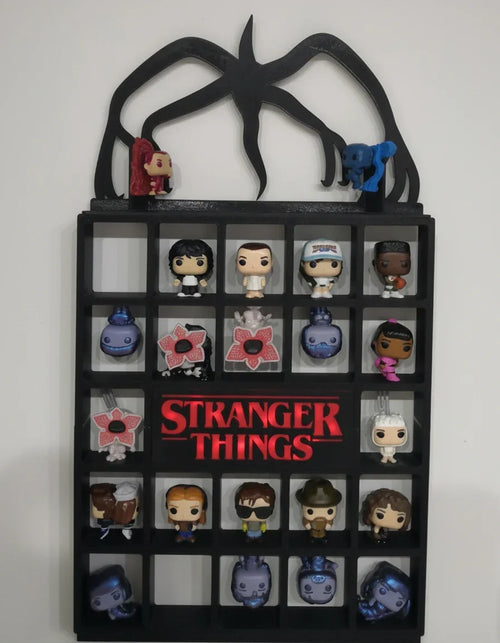 Funko Pop! vinyl figure collection in a 'Stranger Things' themed display case.