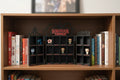 Bookshelf with 'Stranger Things' themed decor and books