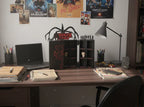 Desk with various items including a laptop, books, and a lamp, with movie posters on the wall.