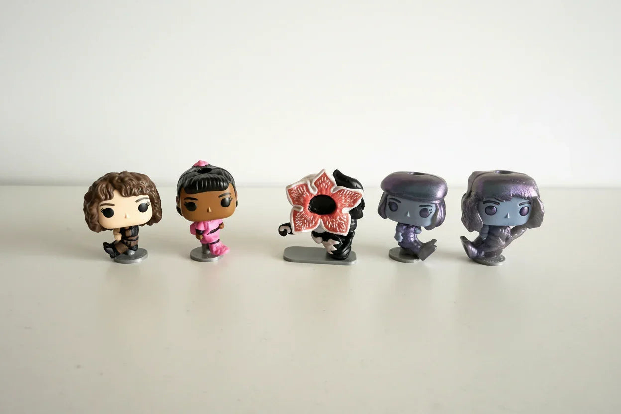 Set of five collectible 3D printed figurines on a white surface, Lunqo modern design toys.