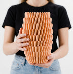 Decorative vase detail highlighting the flowing textured outer form.