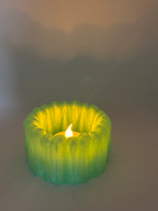 Close view of a lit green BloomGlow organic LED tealight holder