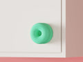 Double-donut cabinet handle mounted on a cabinet