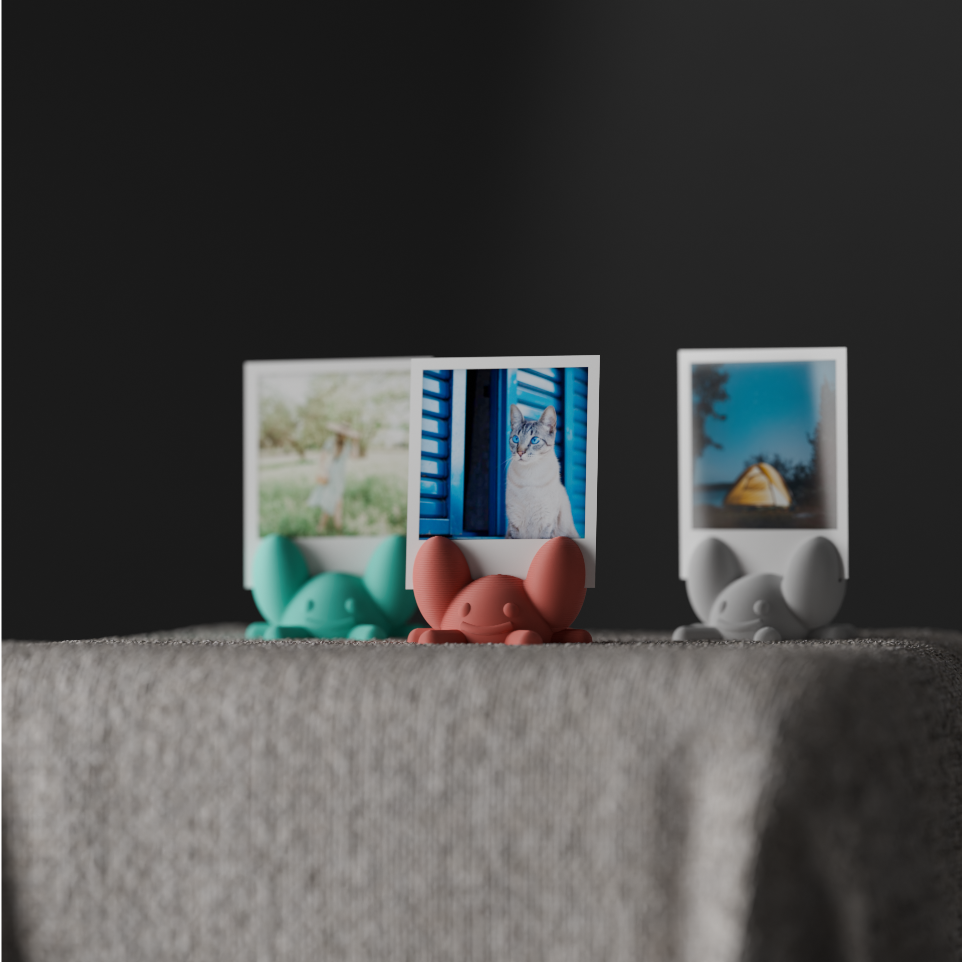 Turquoise, coral and gray crab photo holders displayed together on soft gray fabric
