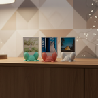 Three colorful crab photo holders styled on a cabinet in a warm geometric interior