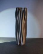 Tall black Flowganic vase shown in a front product view.