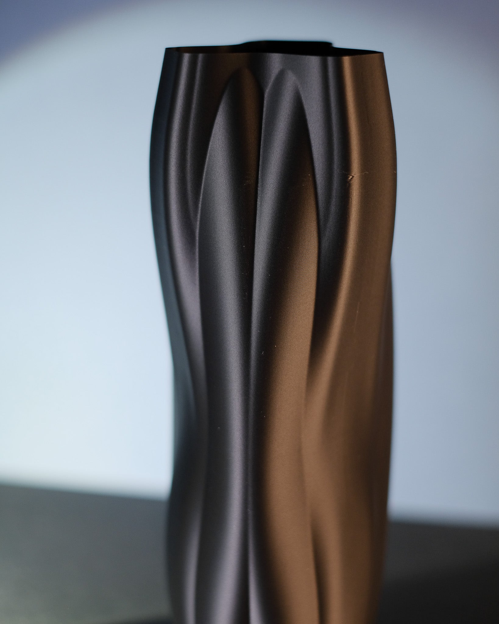 Close-up of the flowing ridged surface on the Flowganic decorative vase.