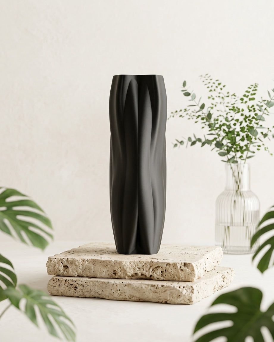 Flowganic vase styled on stacked stone slabs with soft greenery.
