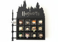Display case with 'Hogwarts' text featuring various figurines on a white background