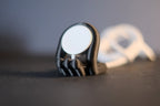 Close-up of the magnetic charging puck fitted into a black Mini Wibble Apple Watch stand