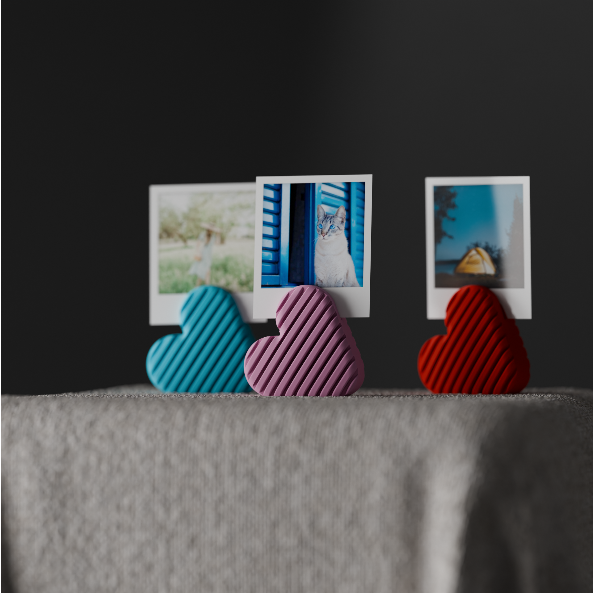 Front view of blue, pink and red heart photo holders arranged with instant photo prints
