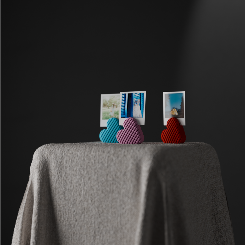 Wide styled scene with three striped heart photo holders and small instant photographs