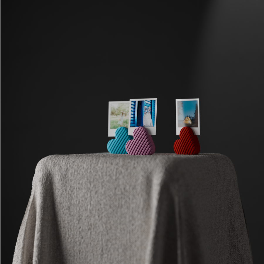 Wide styled scene with three striped heart photo holders and small instant photographs