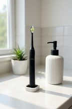 Black electric toothbrush in the compact white draining stand beside a plant and soap bottle