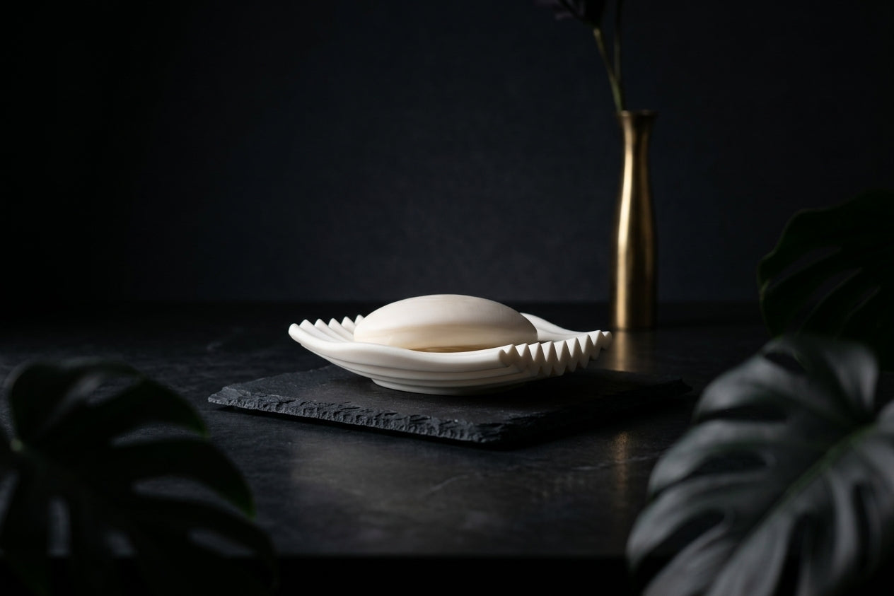 White Rippl soap dish with soap styled in a dark, moody bathroom setting.