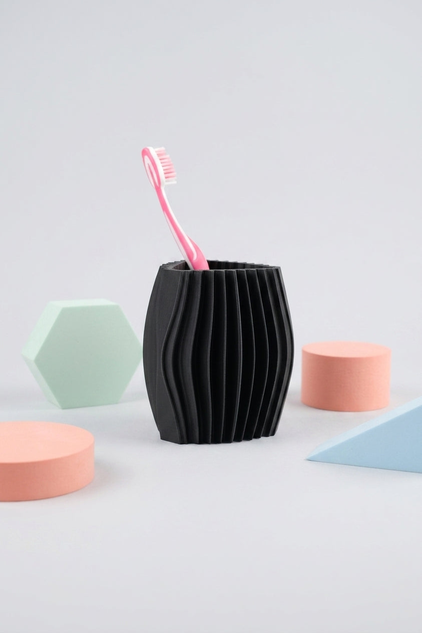 Black wavy toothbrush holder styled with pastel geometric bathroom accessories