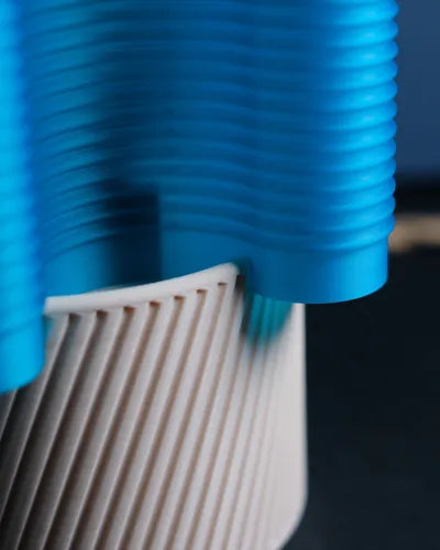 RippleWave E27 lamp illuminated in blue light with a light neutral base