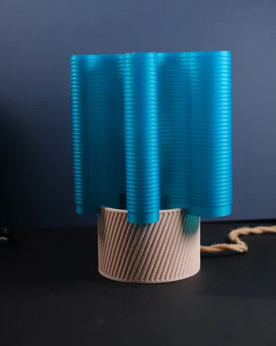 RippleWave E27 lamp illuminated on a dark surface with a blue wave shade