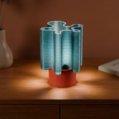 RippleWave E27 lamp glowing on a wooden bedside table