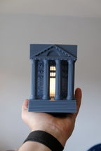 Illuminated Roman temple book nook lamp between books