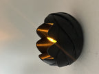 Black rose-inspired tealight holder glowing with an LED light in a close side view