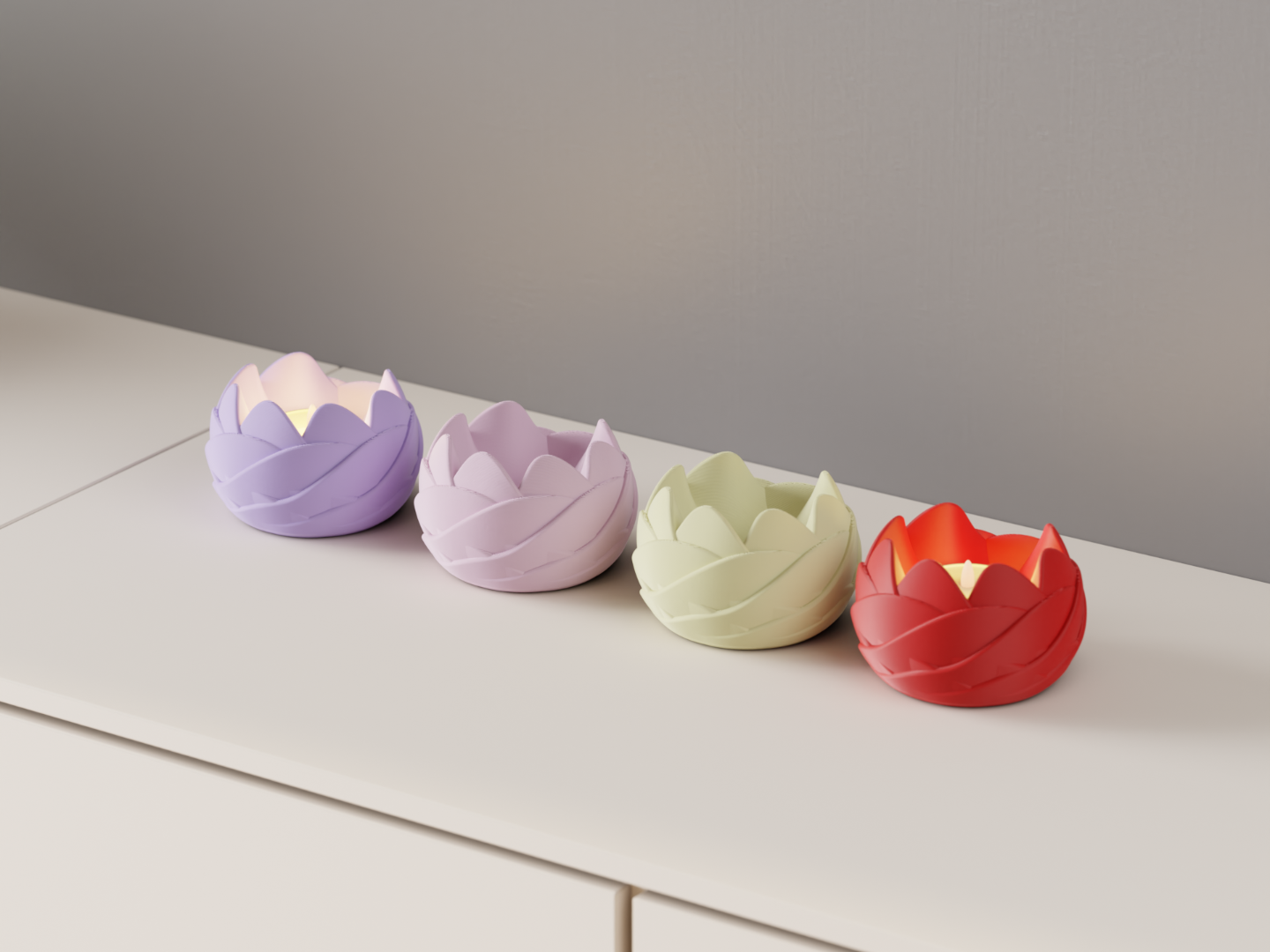 Four rose-inspired LED tealight holders in lavender, pink, cream and red on a white cabinet