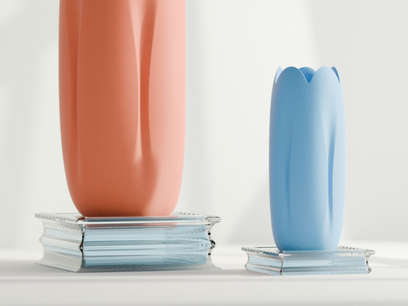 Coral and blue tulip-inspired decorative vases displayed on stacked books