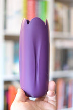 Purple tulip-inspired decorative vase shown in hand to demonstrate its form
