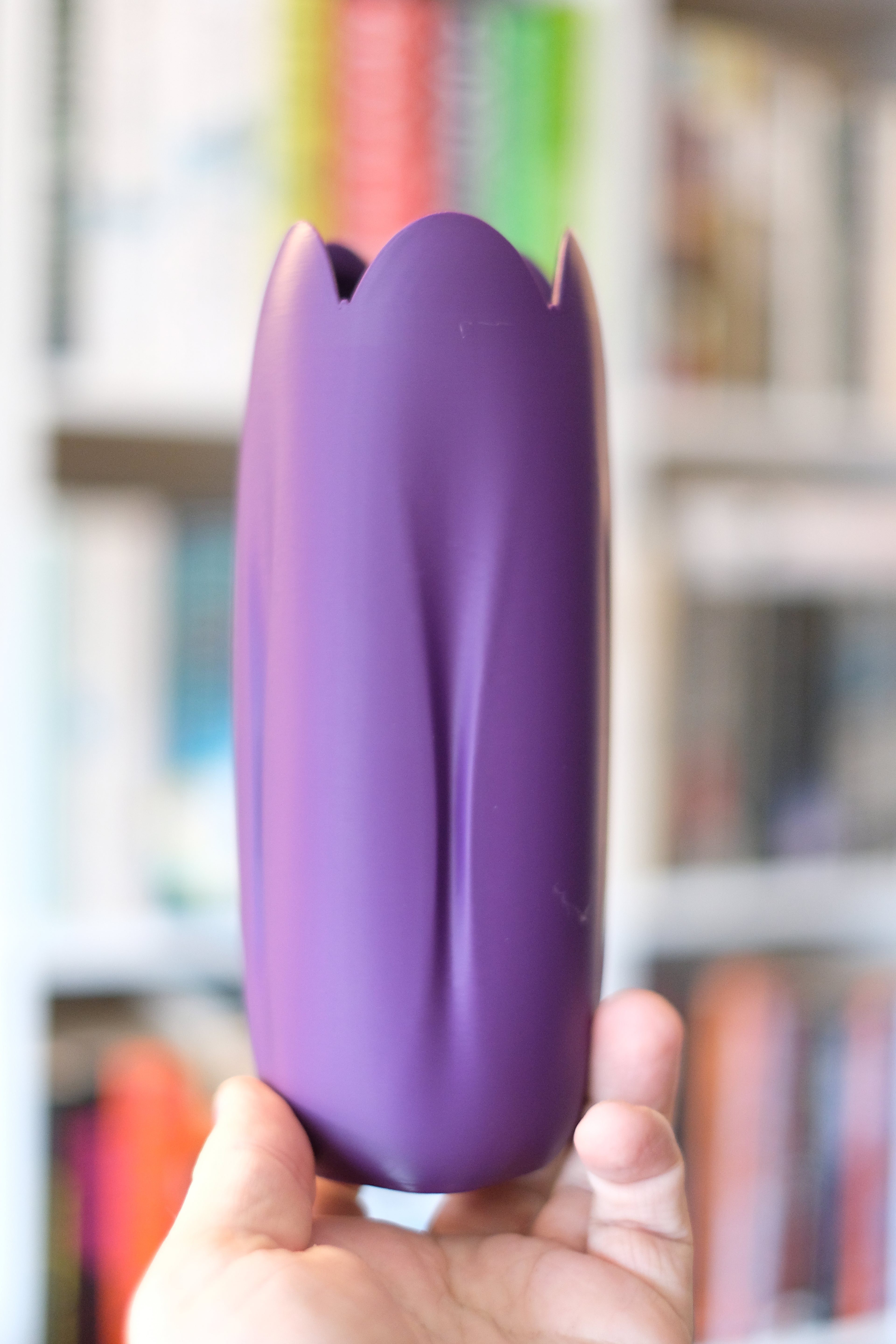 Purple tulip-inspired decorative vase shown in hand to demonstrate its form