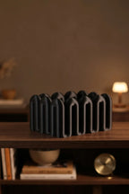 Black Wibble open-top storage box displayed on a dark wooden shelf