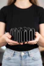 Person holding the black Wibble desktop storage box at waist height