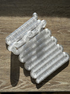 Clear Wibble kitchen utensil rest photographed from above on a wooden surface