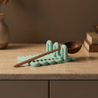Mint Wibble utensil rest with a wooden spoon displayed on a warm kitchen countertop