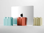 Sculpted vertical laptop stand in a modern workspace